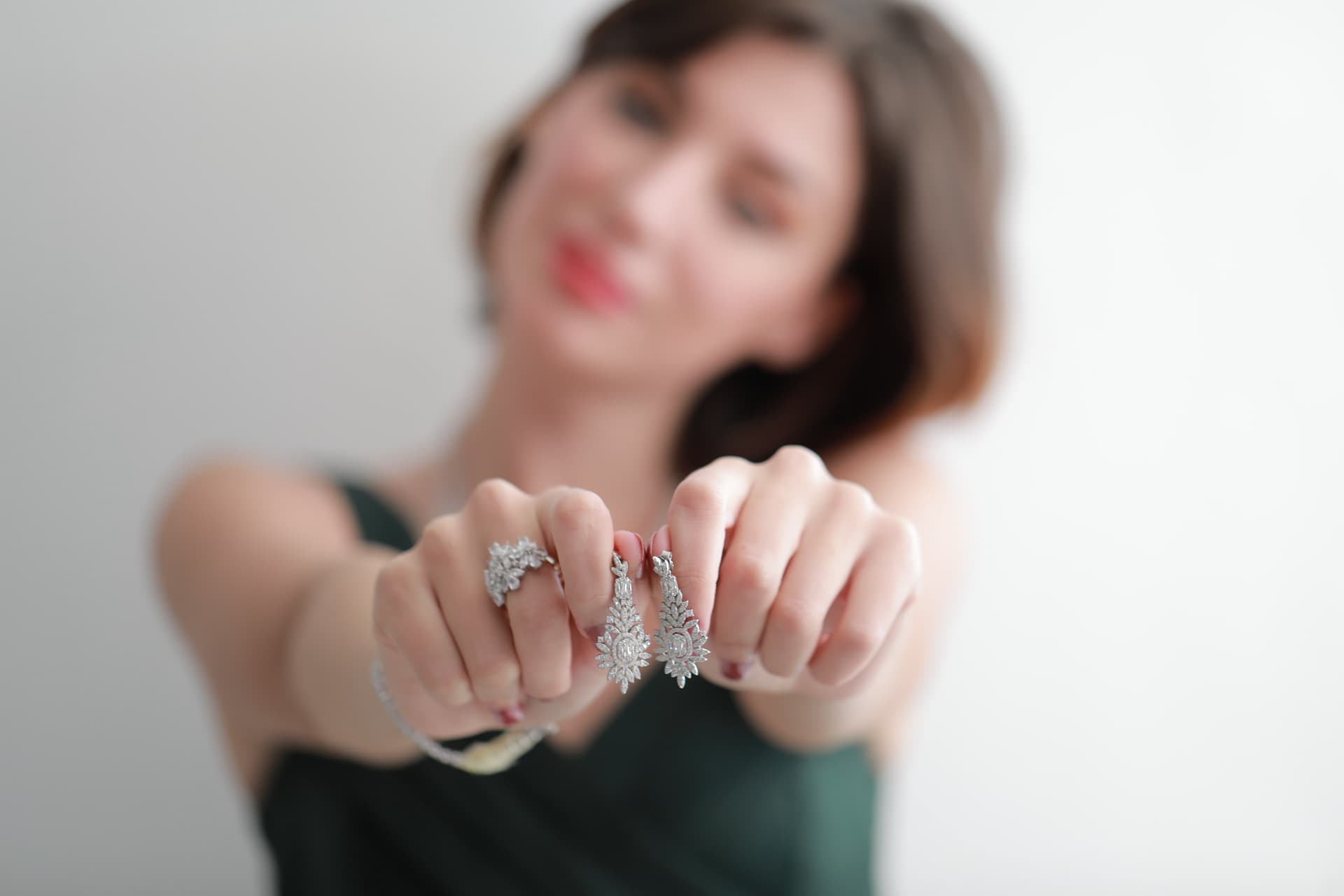 Ilyes Bijoux model holding earrings